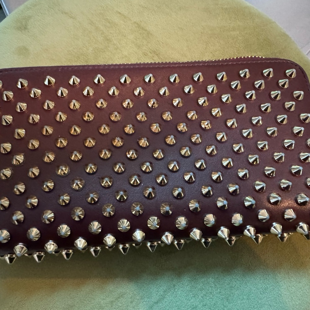 Christian Louboutin brown with pink spikes wallet. Great pre owned condition.